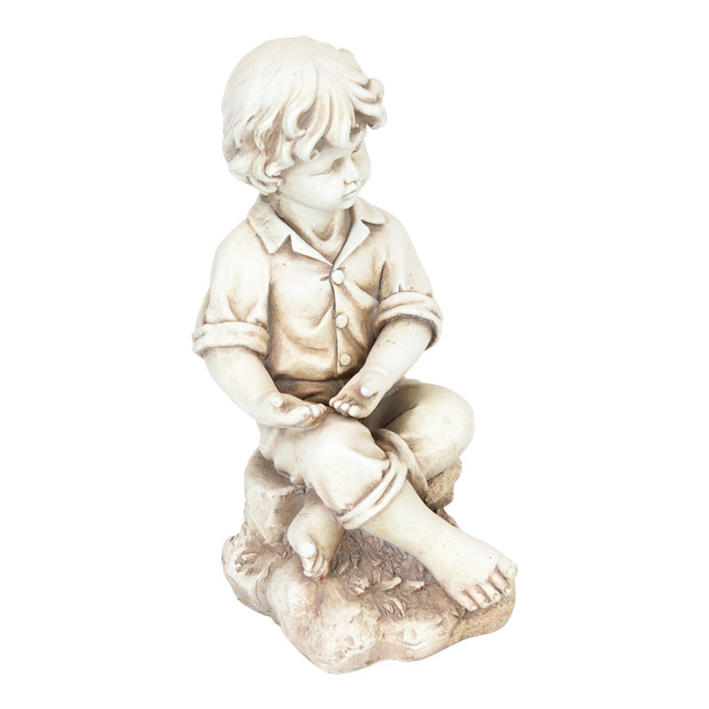 Boy Sitting On Rock Statue